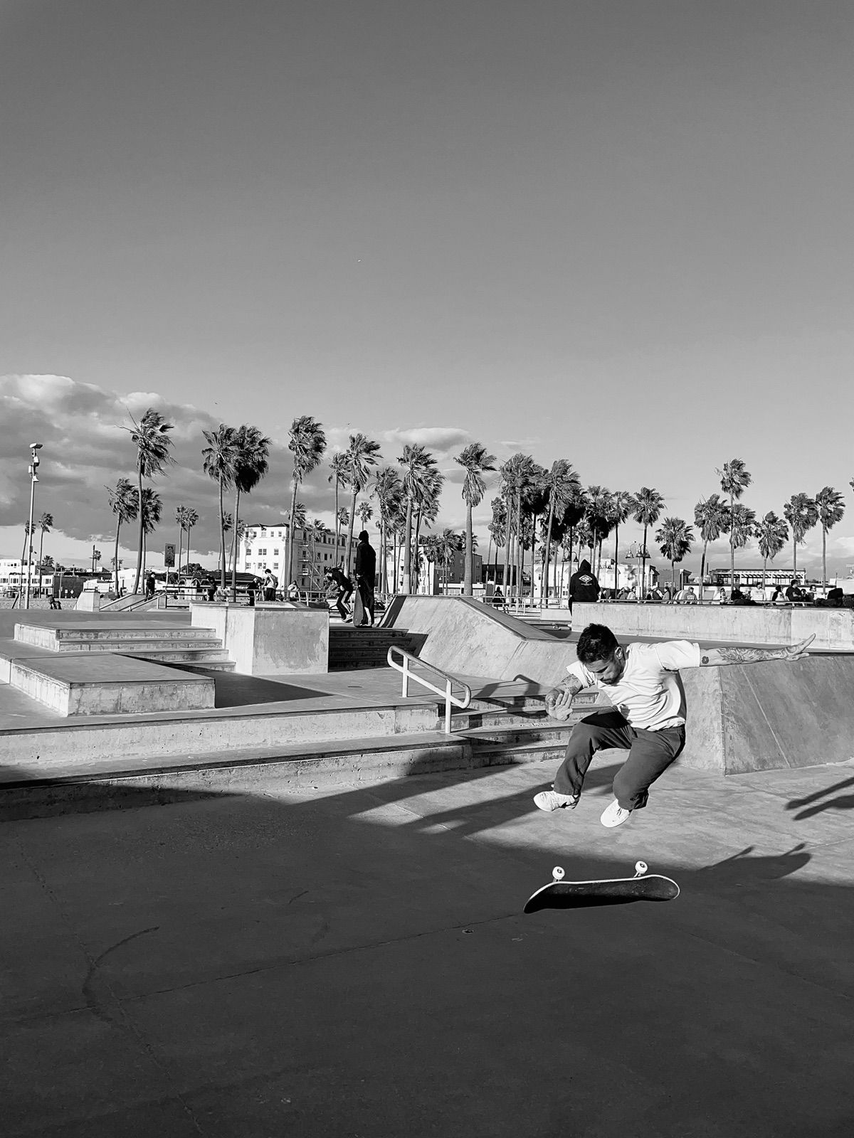 Skateboarding trick at a skatepark, black and white